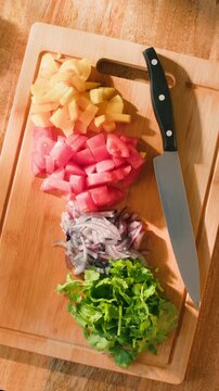 Salad mix, yellow sweet pepper, tomato, cilantro, parsley, Healthy food, Chef hands with knife for onion, cutting and preparation with cooking for dish. Restaurant stew. 