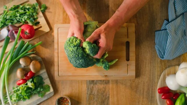 Man chef cooking broccoli, Macro of Broccoli close-up, fresh green broccoli, healthy food, vitamins, raw food and vegetarian lifestyle concept, kitchen vegan food. 