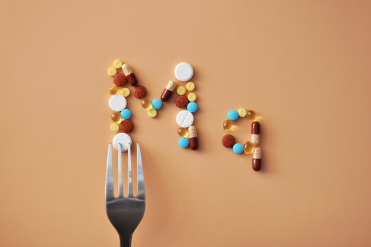 Magnesium Symbol Made of Pills on Fork Representing Dietary Supplement Intake