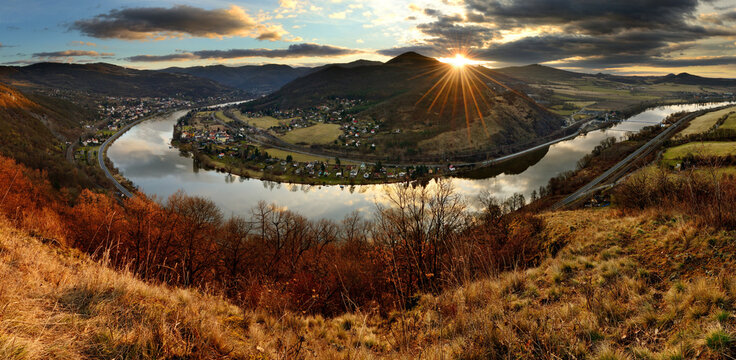 Spectacular 360-degree sunset panorama of the Elbe river meander with sunrays over a volcanic summit