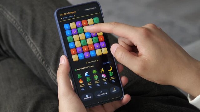 Person plays a colorful mobile puzzle game, reflecting the rapid growth of casual gaming, interactive entertainment and screen-based leisure in everyday life.