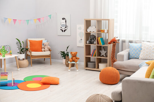 Different toys and furniture in child's room. Interior design