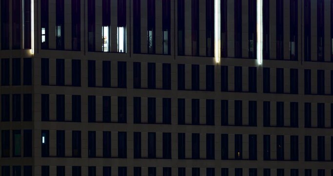 A modern building in the morning, you can see the changing light reflected in the windows.