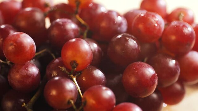 Red grape, spanish supermarket food, Close-up green grape cluster on vine in the vineyard. Stock Photo