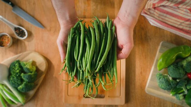Fresh green beans and vegetables on a wooden table, spanish extra fine beans, chinese long bean. 