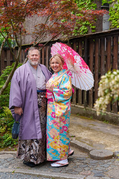 Man and woman couple wearing kimono and yukata in Kyoto Japan garden