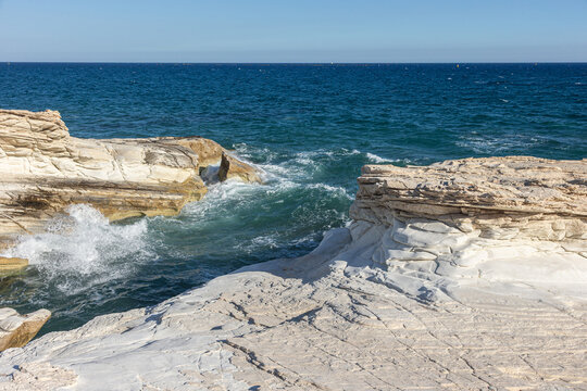Waves Crashing Against White Limestone Cliffs on a Rocky Mediterranean Coastline