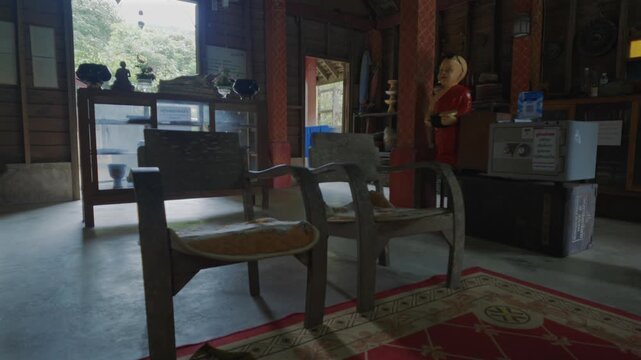Vintage wooden chairs inside traditional Buddhist temple with rustic spiritual interior, Historic monastery room featuring antique furniture and peaceful sacred atmosphere 4k