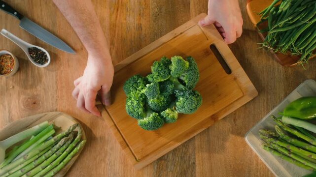 Man chef cooking broccoli, Macro of Broccoli close-up, fresh green broccoli, healthy food, vitamins, raw food and vegetarian lifestyle concept, kitchen vegan food. 