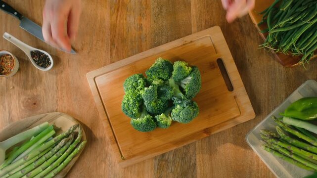 Man chef cooking broccoli, Macro of Broccoli close-up, fresh green broccoli, healthy food, vitamins, raw food and vegetarian lifestyle concept, kitchen vegan food. 