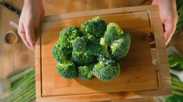 Man chef cooking broccoli, Macro of Broccoli close-up, fresh green broccoli, healthy food, vitamins, raw food and vegetarian lifestyle concept, kitchen vegan food. 