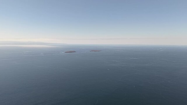 Wide aerial drone shot of deep blue ocean with Marietas Islands in the far background from Punta Mita