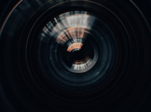 Close-up of camera lens aperture blades and optical elements,Macro,Detailed macro shot of a professional camera lens showing the mechanical aperture blades, iris diaphragm, and precision glass element