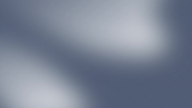 Smooth abstract motion background with soft blue gradient blur and subtle glowing particles for video presentation looping animation.
