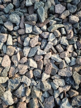  Top view of sharp crushed rocks ballast pile under natural sunlight