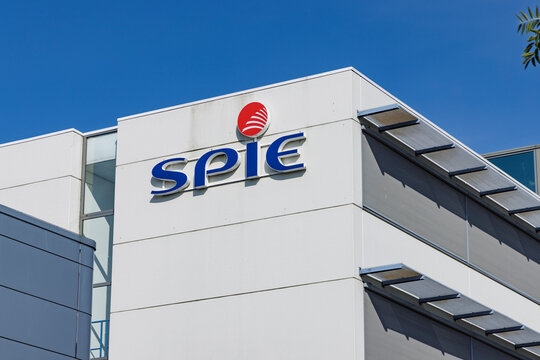 Utrecht, Netherlands - 15 July 2026: Modern office building architectural exterior featuring the SPIE company logo on white facade against blue sky.