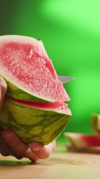 Man cutting watermelon - cut piece with knife. Young watermelons Citrullus lanatus. Topic - melons and gourds, farmer cultivation of watermelons