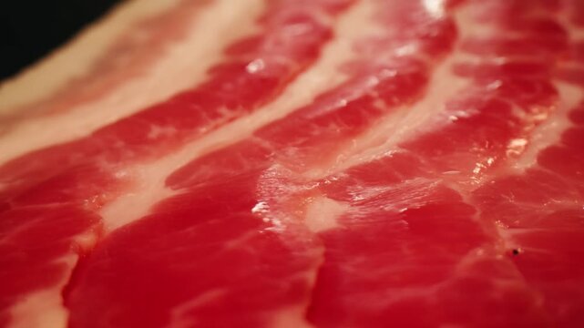  Sliced ham jamon fat bacon meat, beef pastrami thick pieces on a wooden board, beef or pork jamon. Chef cooking breakfast, smoked bacon in cafe. 