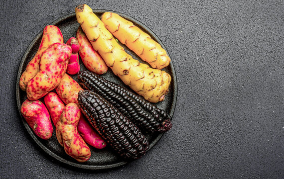 Peruvian raw ingredients for cooking black corn and sweet potatoes. Top view