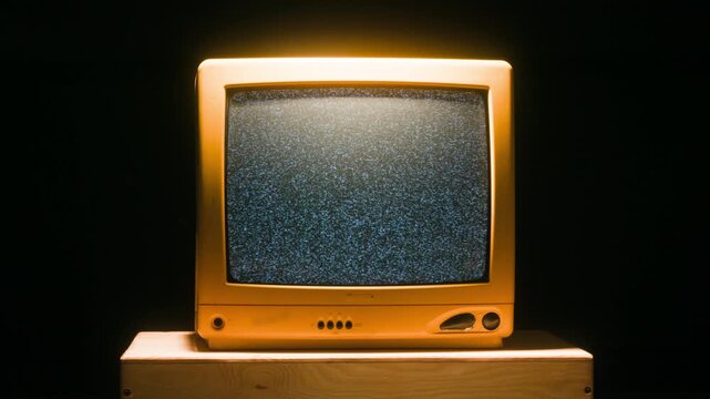 Retro TV, vintage television In a nostalgic setup, a retro TV displays grain on screen, scary halloween night device good for chroma key and green screen