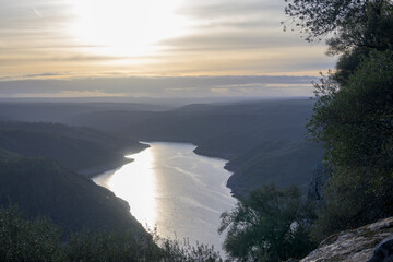 Sunset over winding river valley © MiguelA