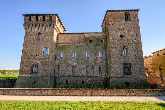 Brick walls and corner towers of medieval San Giorgio castle from the moat wall, Mantua, Italy