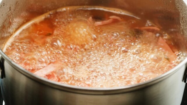 Slavic meat soup, Solyanka sausages soup with sour cream white bowl food, close up of winter soup with ham