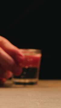 Pouring shot of red bitter, Cognac, whisky, Campari, Aperol, Cherry Vermouth Negroni, spanish wine drink, Alcoholic Americano Cocktail bitter, sweet vermouth and soda water, close up of making drink