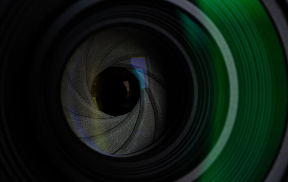 Close-up of camera lens aperture blades and optical elements,Macro,Detailed macro shot of a professional camera lens showing the mechanical aperture blades, iris diaphragm, and precision glass element