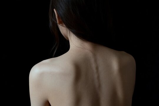 Bare Back and Shoulders Against Dark Background