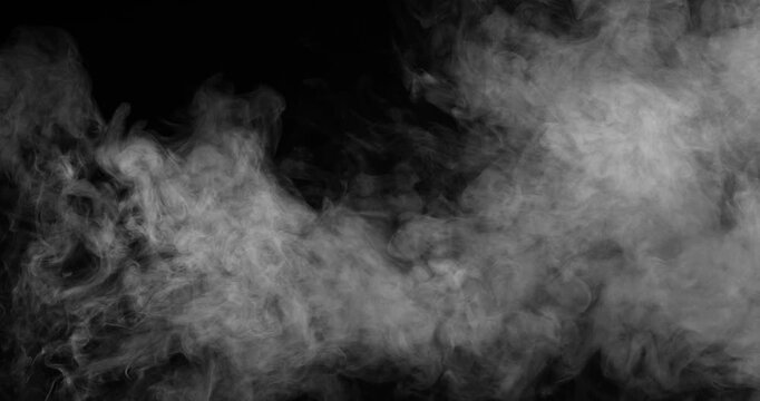 White Smoke is Slowly Moving. White dense smoke slowly whirls against a black background, filling the entire screen