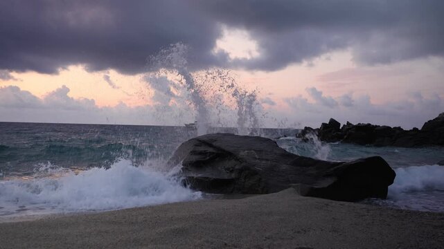 Powerful Wave Splash Over Rocks at Dusk Near Tropea
