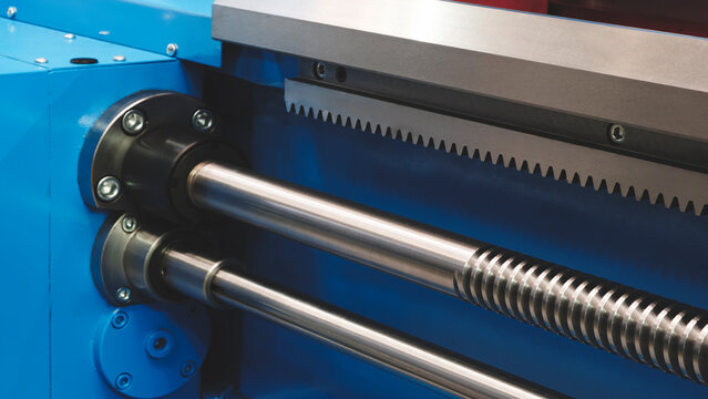 Close up of industrial metal screw shaft as part of screw transmission. tech industrial technology background