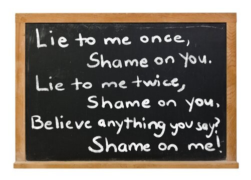 Lie to me once, shame on you written in white chalk on a black chalkboard in a wooden frame isolated on white
