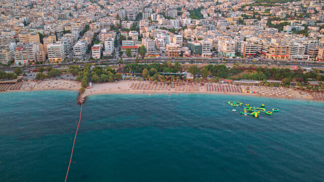 Glyfada beach on the athens riviera offering summer leisure activities with an urban cityscape and the blue aegean sea, representing a popular greek vacation spot