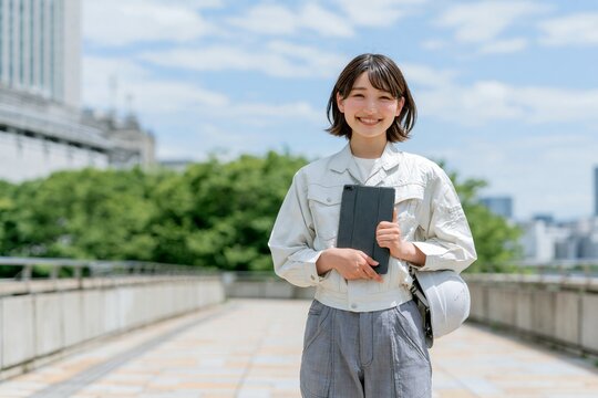 明るい笑顔の日本人女性技術者が未来を創造する建設現場