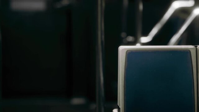 A bus interior shows several empty seats and metal structures. The colors are dark, indicating a typical day. The setting seems to be during morning or afternoon hours.
