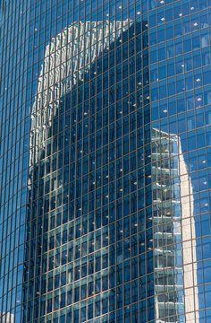 Canada, Alberta, Calgary.  Glass and steel office towers reflecting in each other's windows.