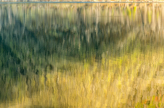 Canada, BC, Loon Lake.  Undulating reflections on the surface of the lake.