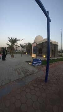 Explore the historic Masjid al-Suqya and its informative heritage sign in Medina.