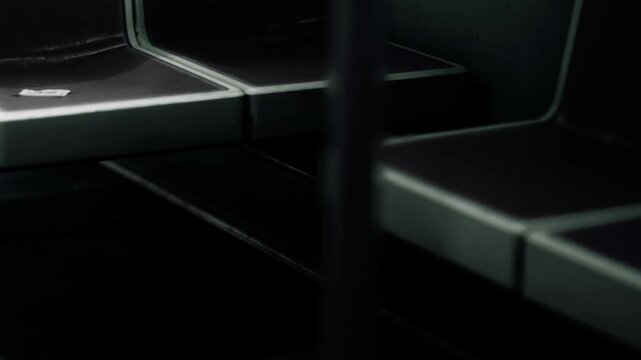 Shelves are empty and dark in a storage area. There is little light showing the shapes of the shelves. The atmosphere suggests it is evening and items are not present.