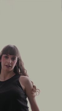 Young energetic woman dancing expressively isolated
