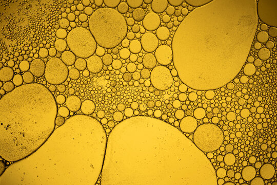 Oil drops mixing with water creating abstract texture