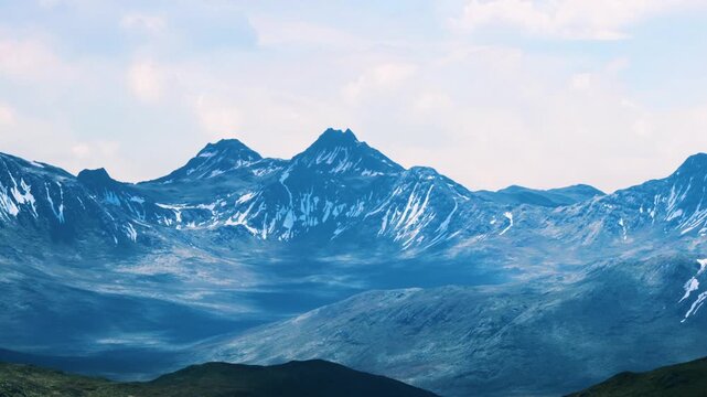 The scene shows a range of mountains with some snow covering their peaks. The sky is cloudy and the mountains stretch far into the distance with varying shapes and sizes.