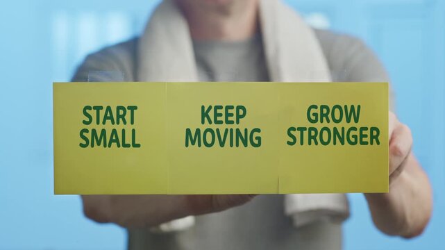 Fit man showing a motivational message with the words start small, keep moving, grow stronger on yellow sticky notes, symbolizing personal growth, progress, and achieving goals