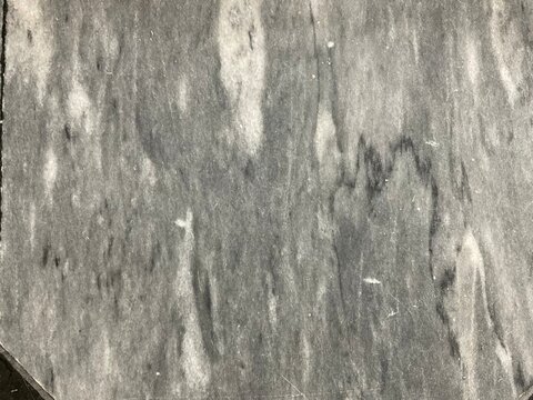 This surface appears to be honed dark grey marble, a natural stone composed largely of dolomite and calcite.
It shares characteristics with Afyon Grey Marble, which is known for distinct veining a
