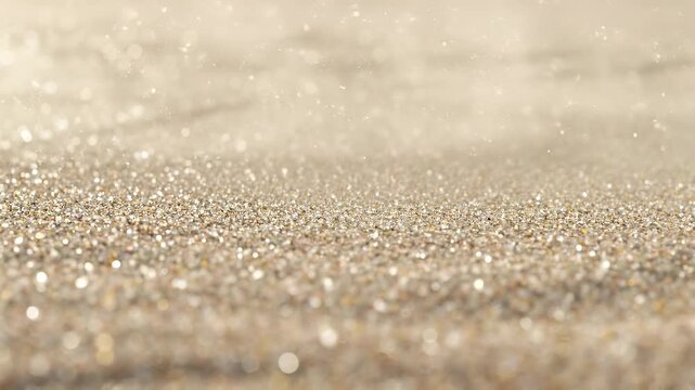 Close-up of sparkling golden sand grains shimmering under bright sunlight at the beach