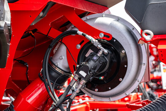 Agricultural seeding machinery pneumatic blower fan with hydraulic drive. Modern precision farming planter air compressor component on red frame and industrial engineering technical details.