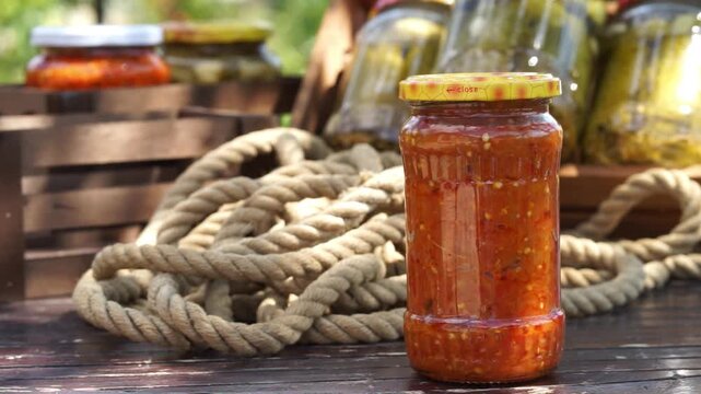 Assorted pickled vegetables in glass jars preserved in vinegar for homemade food storage, fermentation and pantry concept