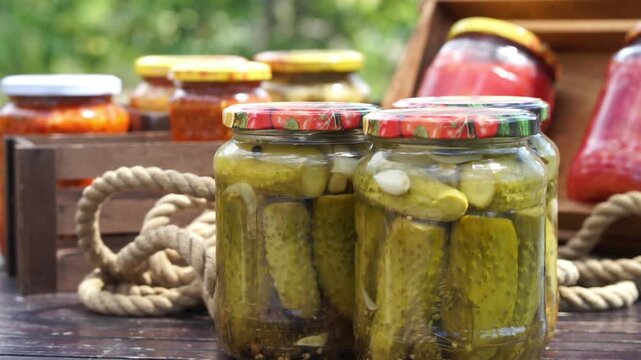 Assorted pickled vegetables in glass jars preserved in vinegar for homemade food storage, fermentation and pantry concept